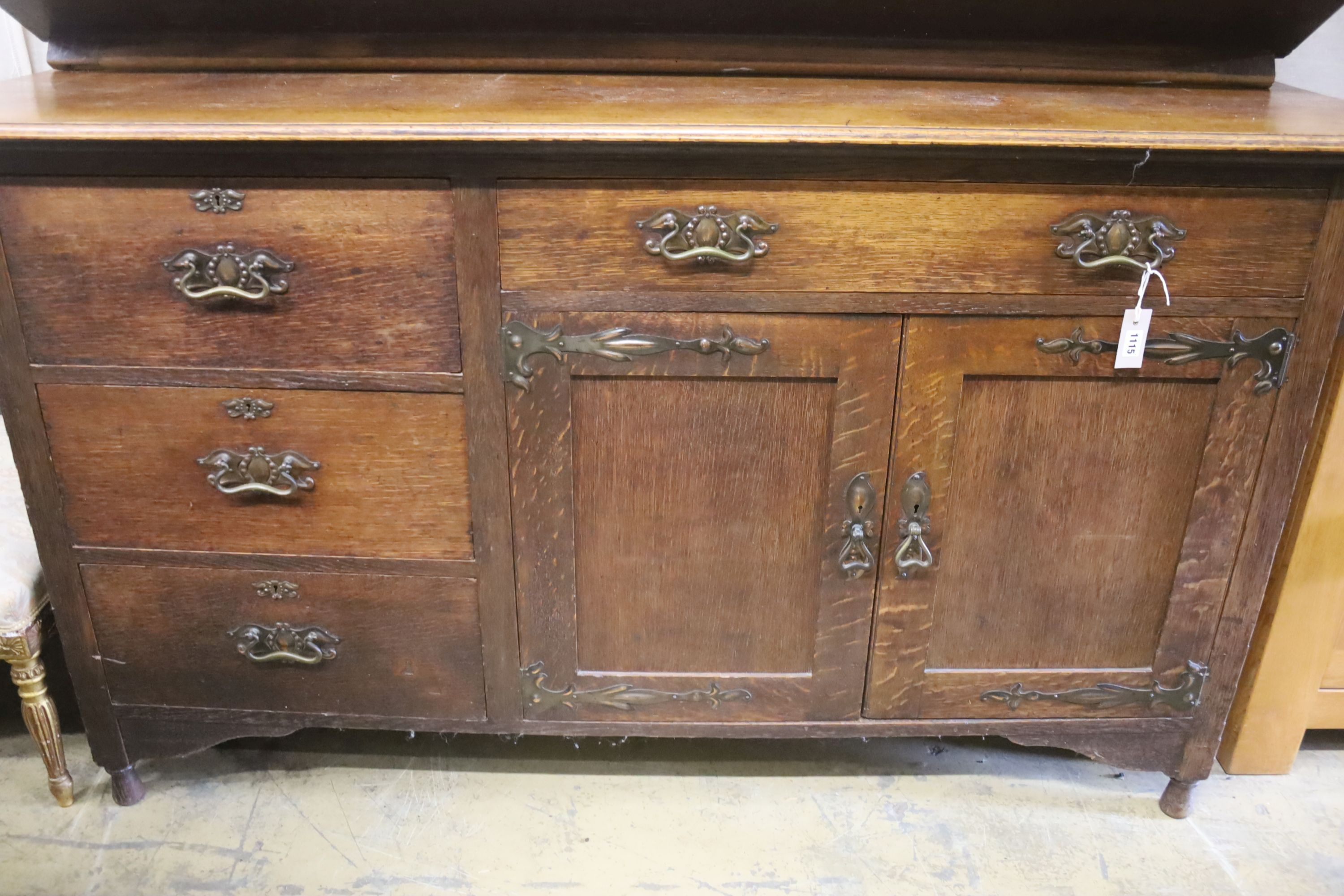 An Arts & Crafts style oak sideboard with stained glass dolphin panels, length 182cm, depth 60cm, height 145cm (lacks top section suppo